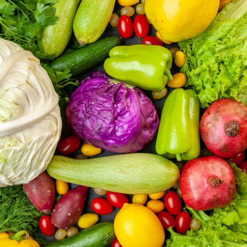 top-view-vegetables-fruits-zucchini-bell-peppers-apples-quince-cherry-tomatoes-cumcuat-parsley-cabbage-lemon-pomegranates